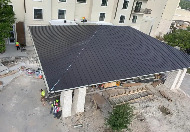 Metal roofing installation team working on a commercial building in Josephine